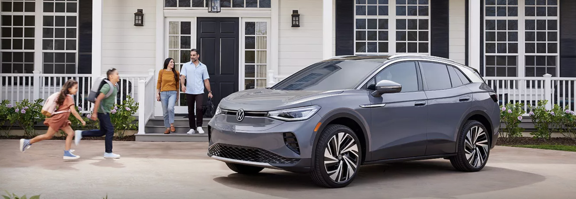 New 2025 VW ID.4 in front of a family house