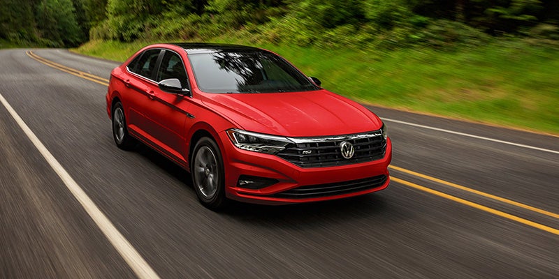 A Volkswagen Jetta driving on a road