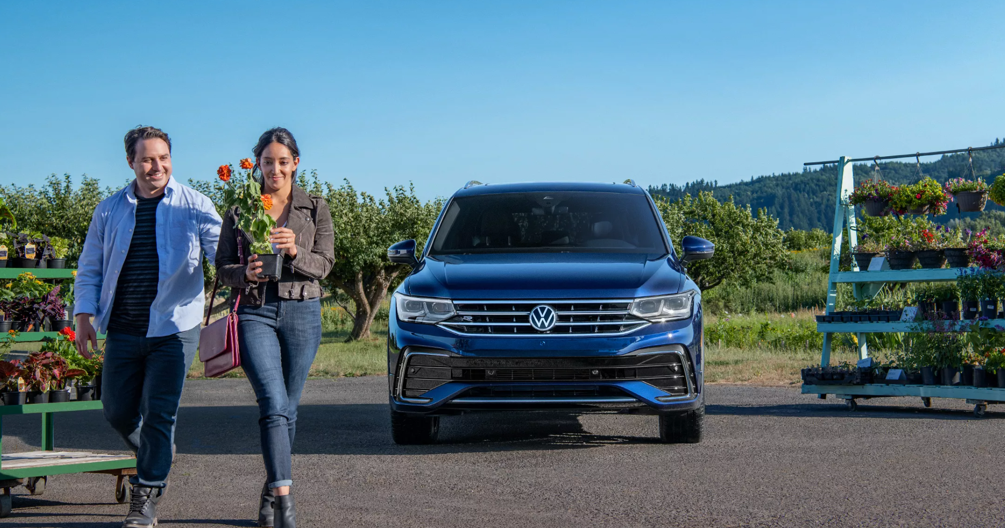 New Volkswagen parked near a flower garden 