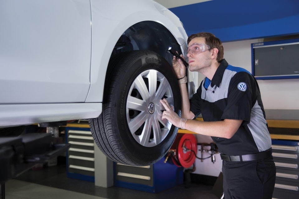 Volkswagen service technician working on a car
